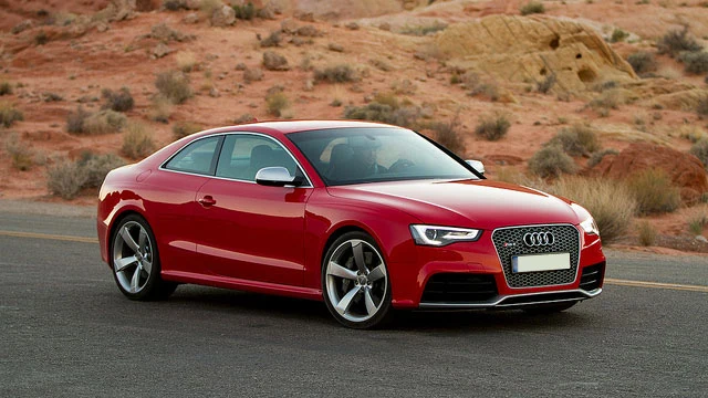 A red Audi coupe on a desert road; illustrative vehicle photograph by Josh Sniffen